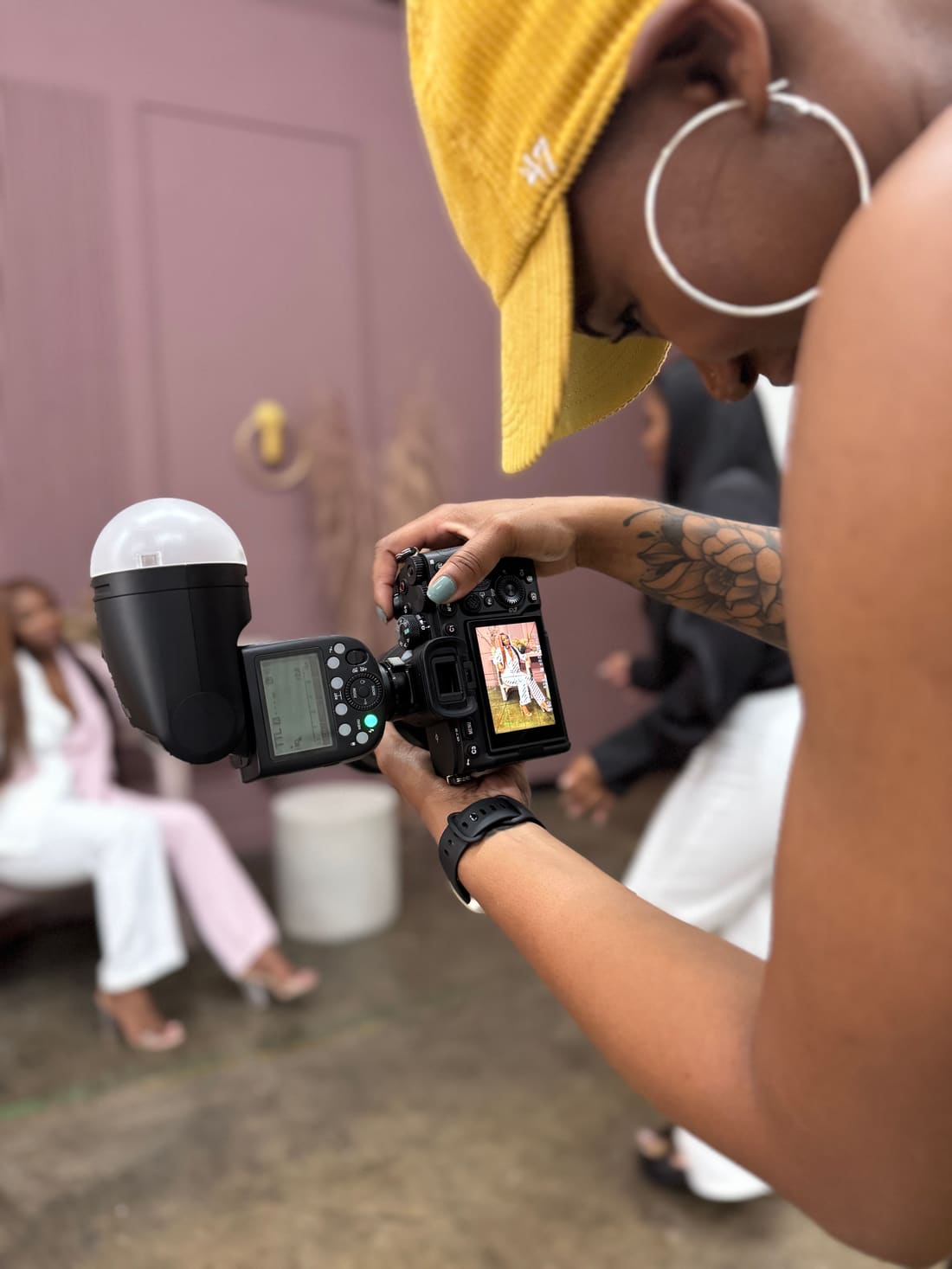 Color photo of Nikki behind the camera on a film day, checking a shot on the display
